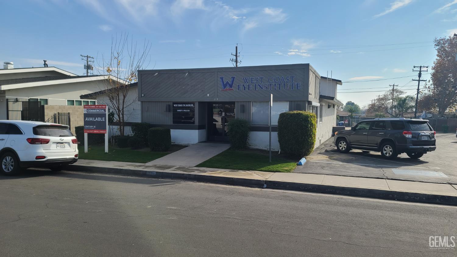 Commercial building housing West Coast Eye Institute, with street-side parking and a prominent facade sign.