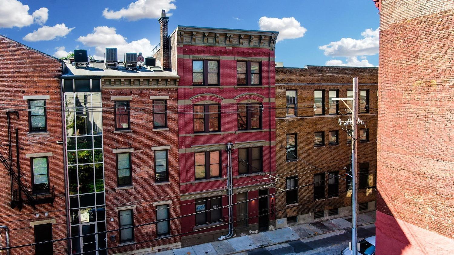 Impressive condo in the heart of OTR! Secure gated entry, 2 levels of living space, gourmet kitchen w/large quartz island, counter bar & SS appliances, exposed brick, tall ceilings, custom blinds, hardwood floors & laundry in-unit. Private deck w/a view of the park.  Low HOA dues and tax abated to payable 2026.  Seller will pay for 1 yr. of parking for 1 car at Washington Park Garage. Block(s) from Vine St., Washington Park, FCC Stadium & Findlay Market!