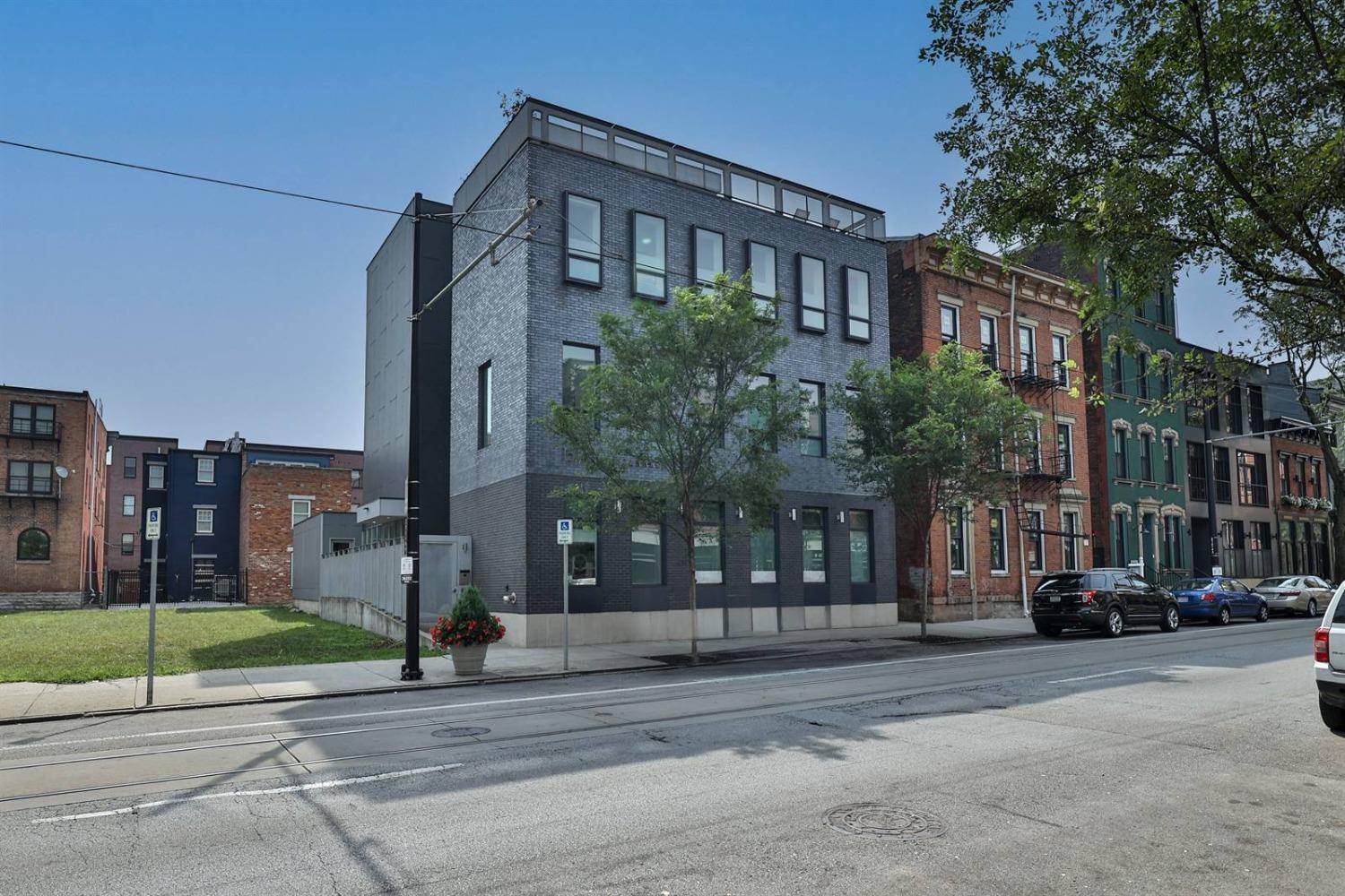 Why settle when you can have this sleek, contemporary 1400+ SF unit. The epitome of luxury living in OTR. Private entry & patio, 10' ceilings, 2 primary ensuite bedrooms. Closet space galore. Storage room. 1 garage space in 6-year-old LEED Gold and AIA award-winning 3-unit building. On the streetcar line. Walk, wheel, bike, ride to restaurants, entertainment, parks & everything OTR & downtown have to offer. Tax abated thru 2032-payable 2034. HOA allows short term rentals. Owner manages units as short-term rentals. Can be bought together with units 2 and/or 3.