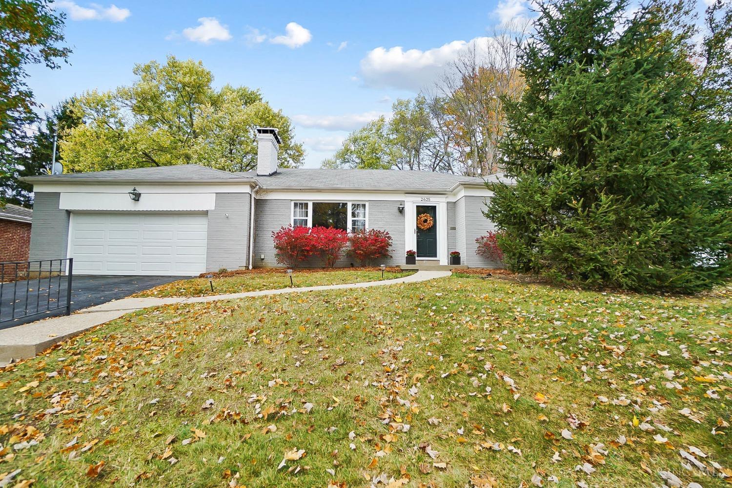 Beautifully updated Ranch with fantastic yard on a quiet cul-de-sac street! Spacious Living Room with hardwood floors, wood burning fireplace, and coved ceilings. Dining Room open to Kitchen with new Quartz counters, subway tile, and refrigerator. New Full Bath with double vanity and tile tub/shower. Newer vinyl Windows, AC, electric panel. Large three season room that overlooks the flat, fenced yard! Finished Family Room in lower level. Laundry on first floor or basement. 2 Car Garage with new opener and door 2023. Convenient location to downtown, grocery, shops, Mount Lookout, and trails at Lunken.