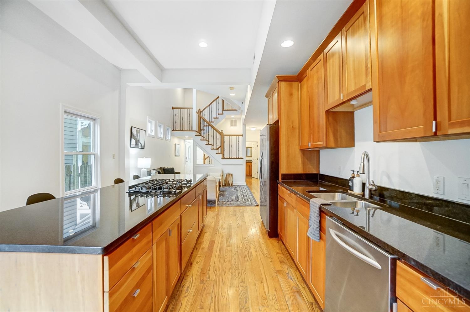 This modern contemporary getaway in the heart of Mt. Adams offers the perfect blend of style and comfort. Freshly painted throughout with three spacious bedrooms (two ensuite!) and three full bathrooms, this home is designed for both relaxation and entertaining. The open-concept floor plan boasts sleek finishes and tons of natural light, flowing seamlessly into multiple outdoor spaces including third floor family room that leads to the rooftop deck, perfect for hosting gatherings or enjoying quiet evenings. An extravagant top-to-bottom staircase serves as a stunning centerpiece, adding architectural flair to the home's modern design. A private garage adds convenience, while the vibrant Mt. Adams neighborhood, known for its charming streets, dining, and nightlife, is just steps away. This is urban living at its finest!