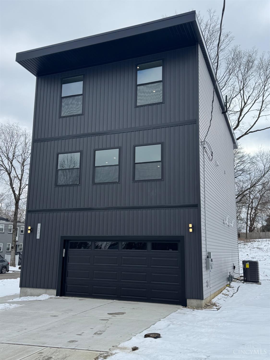 Stunning New Build in Walnut Hills. 4 bedroom, 3.5-bath home blends modern style with thoughtful design. The 1st floor features a private office, mudroom, bedroom, and full bath with an oversized tub/shower. The 2nd floor boasts modern kitchen with an oversized island, pantry, and open-concept dining perfect for entertaining plus a spacious living room with deck access. The 3rd floor offers a luxurious owner's suite with a spa-like shower, double vanity and a large walk-in closet, along with two additional bedrooms with soaring 10-ft ceilings, a full bath, and a laundry room. A 2-car garage includes an EV hookup. Conveniently located near I-71. 2380 sqft. Tax Abatement Eligible!