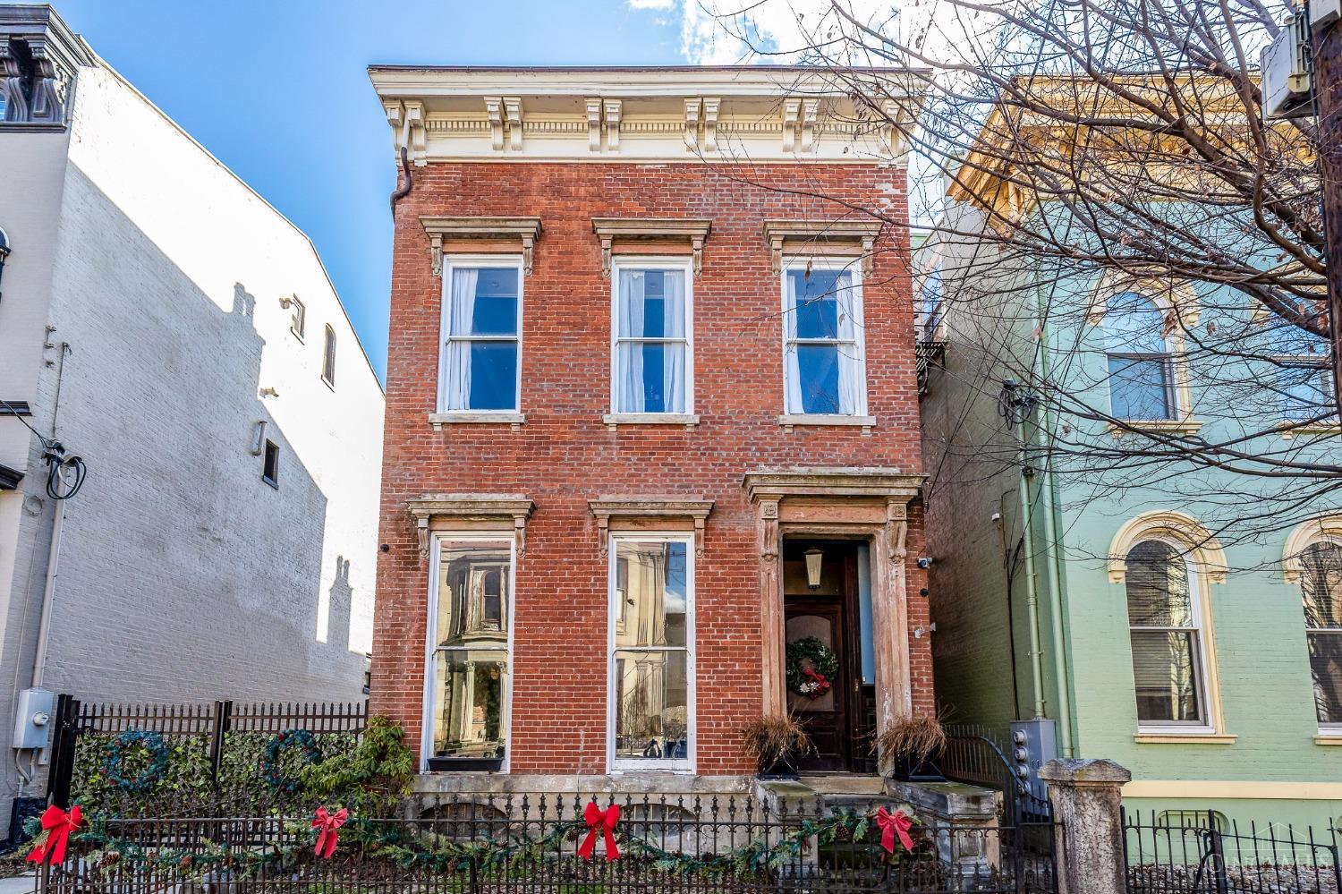 RARE OPPORTUNITY in the Prestigious Millionaire's Row, West End Dayton Historic District! Over 4,000 sq. ft. of meticulously preserved 1860s history, complete with gated parking, a private yard, and a charming carriage house. Original oak doors, moldings, and casings greet you throughout the home, highlighted by soaring 12-foot ceilings in every room. Enter through a secure, gated paver driveway that opens to a tranquil courtyard, with the 2-story carriage house nestled at the rear. The grand parlor flows seamlessly into the expansive living room, which leads to an impressive chef's kitchen and generous dining area. The dry, stone basement boasts 12-foot ceilings and offers a vast space ready for customization. Spacious bedrooms, large walk-in closets, and an oversized ensuite in the primary suite ensure luxurious living. This exceptional property won't last longschedule your showing today!