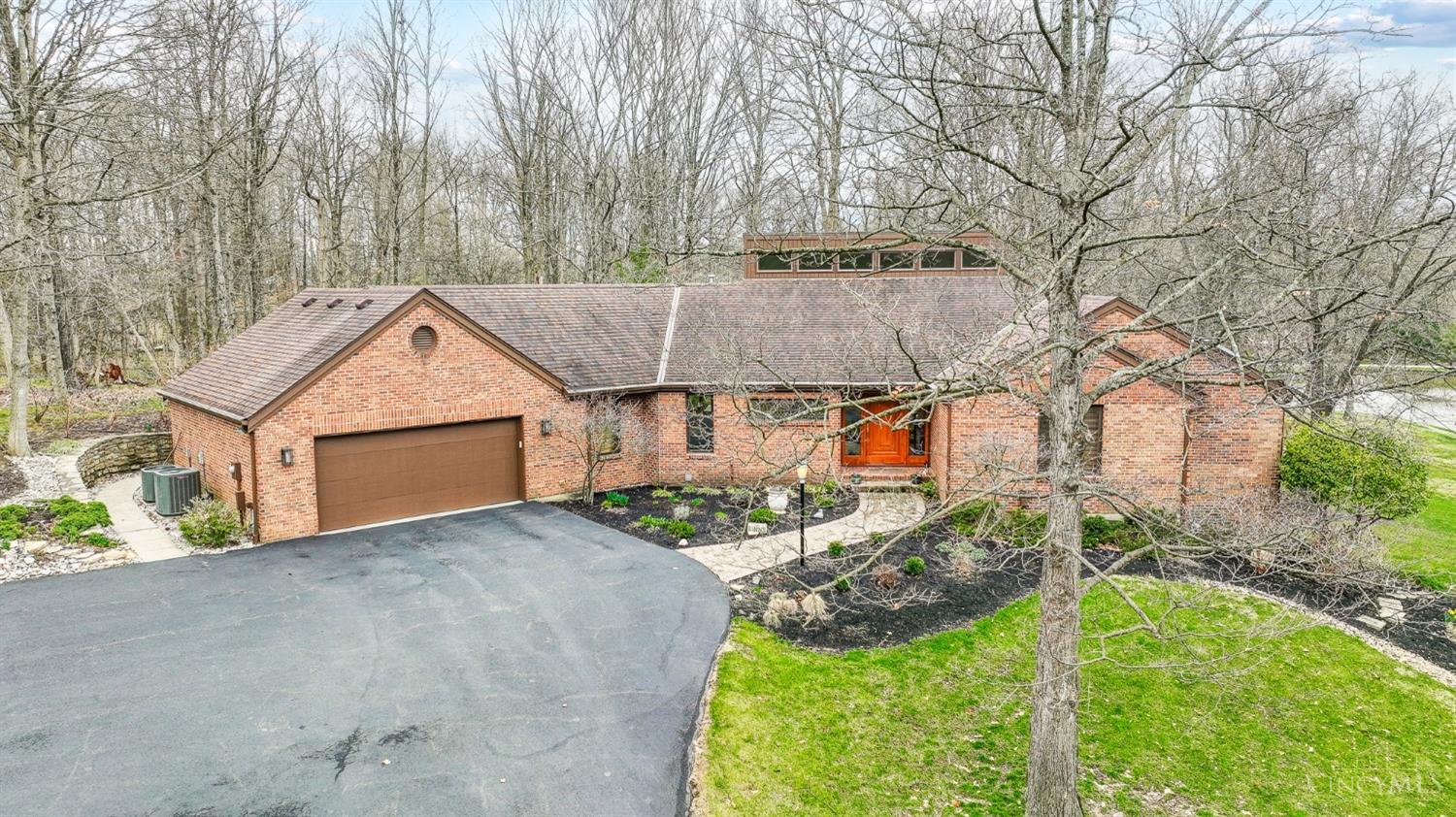 Unique 4 bedroom 3 full 2 half bathroom contemporary ranch situated on over 2 wooded acres with lake views! Impressive entry leads to living/dining room with vaulted ceilings overlooking lower level family room; remodeled eat-in kitchen with large island, breakfast area & sitting area that walks out to parklike paver patio area; first floor primary suite with cathedral ceilings includes walkout to private balcony with lake views adjoining full bathroom with double vanities, shower, jetted tub & walk-in closet; lower level includes game area, family room with fireplace, wet bar & walkout to large patio area; lower level bedroom with walkout to patio.