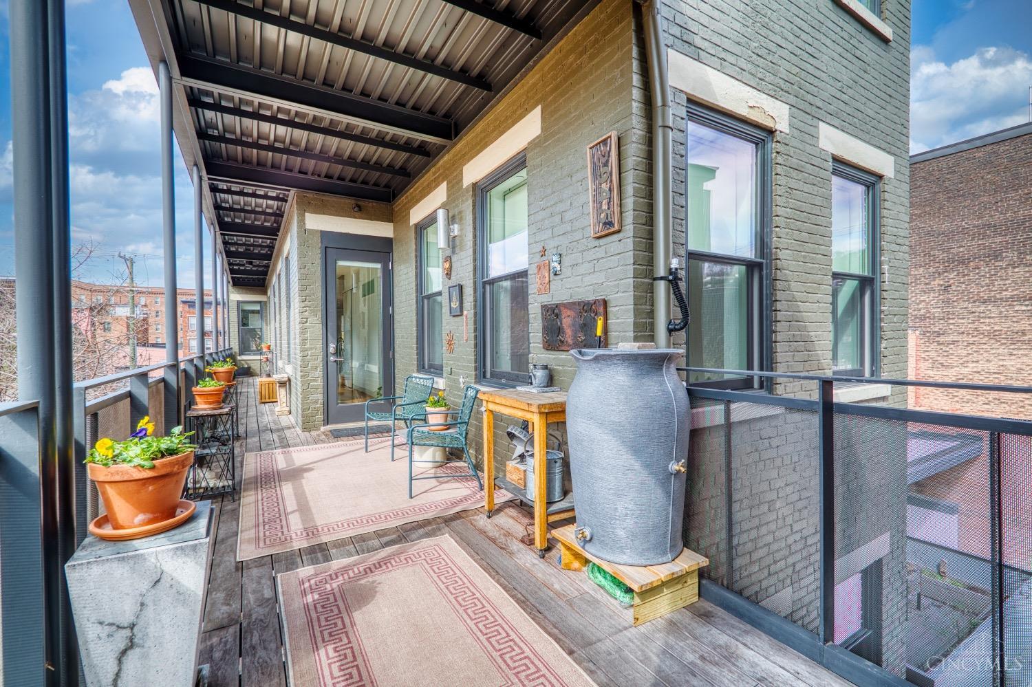 Rare opportunity in vibrant Findlay Market neighborhood! Tax abatement through 2032! Spacious top floor, two level condo with modern finishes, 2-story ceilings, and expansive covered deck! This is the epitome of convenience being just steps from Findlay Market, hip restaurants, trendy shops, and the street car. Grab some groceries and enjoy cooking in your European style kitchen with quartz counters, stainless appliances, and huge island with counter bar OR grill and dine al fresco on your private covered deck! Relax in your open and airy Living Room with recessed ceiling and loads of natural light. Both levels offer bedrooms with stunning baths offering floating vanities and zero entry showers. Striking hardwood floors throughout! All appliances stay, including washer + dryer. Easy parking in newer Findlay Garage just a block away! This is THE ONE!