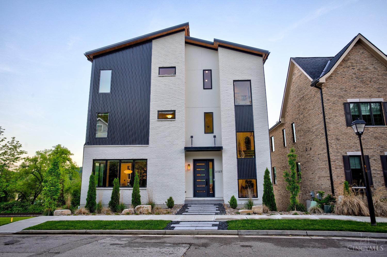 Welcome to 3107 Walworth Avenue. Architectural excellence meets luxury living in this custom-built masterpiece. This four-story home in Walworth Junction offers breathtaking city and Ohio River views from multiple patios and expansive, light-filled rooms thanks to oversized, thoughtfully placed windows. The gourmet kitchen blends seamlessly with the open-concept living space, showcasing elegant countertops and top-tier finishes. An elevator provides access to all levels, including a finished basement, and a 3 car garage entry. The spacious primary suite features a spa-inspired bath with soaking tub, floating vanity, and walk-in shower. Jack and Jill bedrooms, an additional fourth-floor suite, and a stunning entertaining space with wet bar complete the layout. Located on the first lot of this premier development adjacent to shared greenspace, this home is just minutes from downtown, the freeway, & the iconic Precinct. Every detail, curated to perfection.