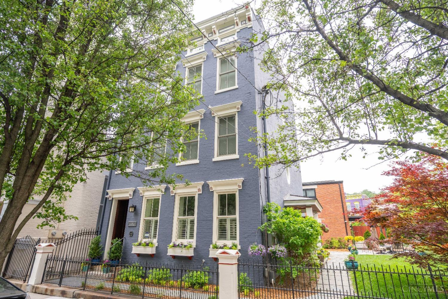 Nestled on a double lot in the heart of OTR, this stunning Italianate home includes historic charm & modern convenience. Completely renovated in 2018, this LEED Platinum-certified home boasts a new carriage house with a 1 BR/1 bath apt. above (4th BR & 4th Full Bath), extra-large 2-car garage & carport. Tax abatement until 2034 makes payments similar to a $1,555,517 home. A light-drenched open floor plan, Rookwood-tiled entry and fireplace, flows seamlessly for entertaining. Expansive 2nd-floor primary suite offers custom built-ins, dressing area and spa-like bath. 4th-floor study opens to a roof-top deck w/composite decking and gazebo. Enjoy geothermal heating/cooling, 36 solar panels (10kw), and 1,000-gal rainwater system. Exterior painted 2024. A sustainable dream home awaits!