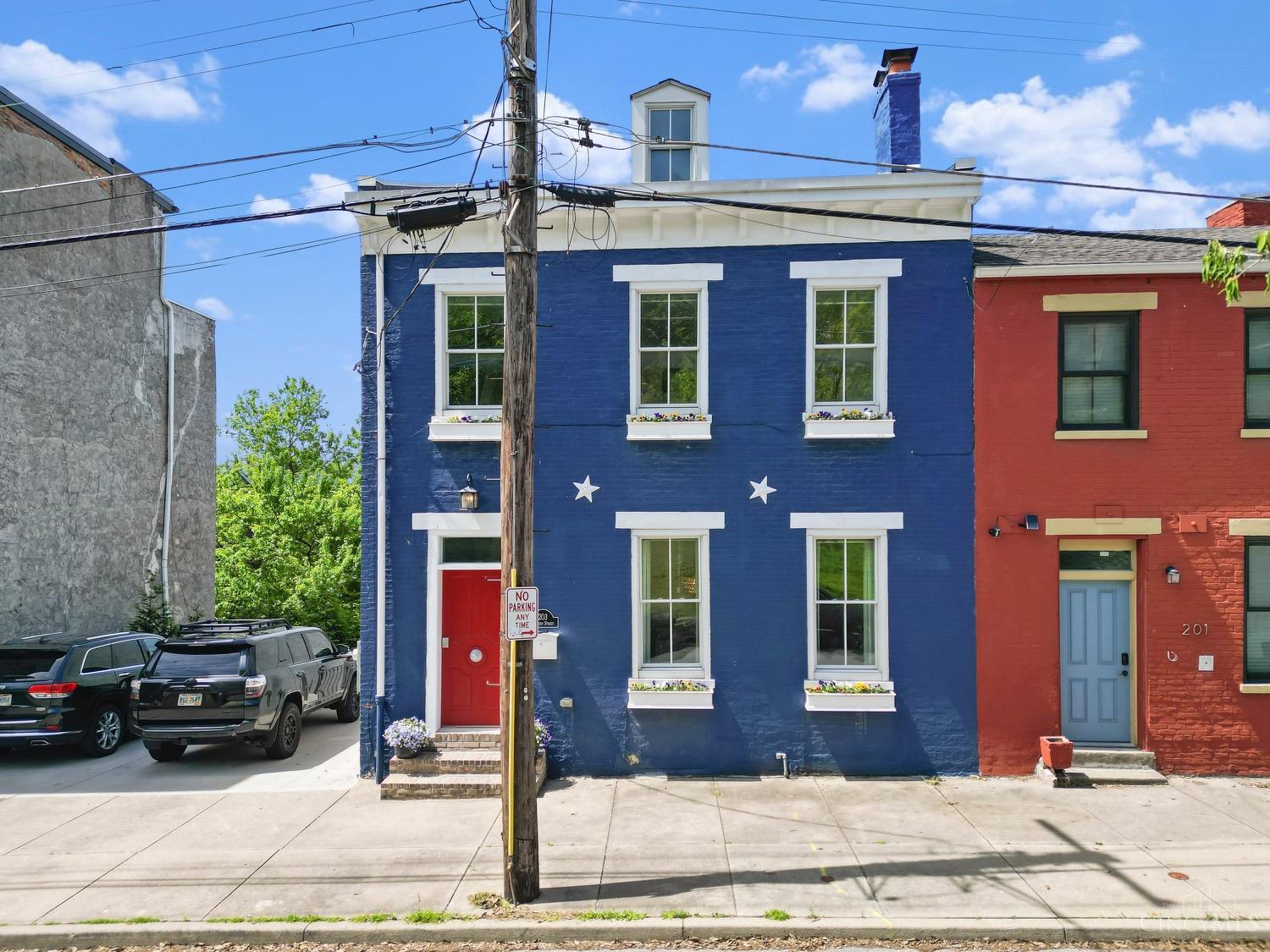 Discover this exceptional 2-bedroom, 3 full/2 half-bath home located just steps from the heart of Over-the-Rhine. Perched to capture sweeping views of Cincinnati's iconic skyline, this fully updated residence combines historic charm with modern luxury. Enjoy beautiful wood floors throughout, custom woodworking details, and a thoughtfully finished basement perfect for a home office, gym, or additional living space. The third-floor living room offers city views w/ large deck (& mini split system). Outside, the rare double lot provides a private urban oasis, complete with 2-car parking. A true gem in one of Cincinnati's most vibrant neighborhoods! Tax Abated Until 2028.