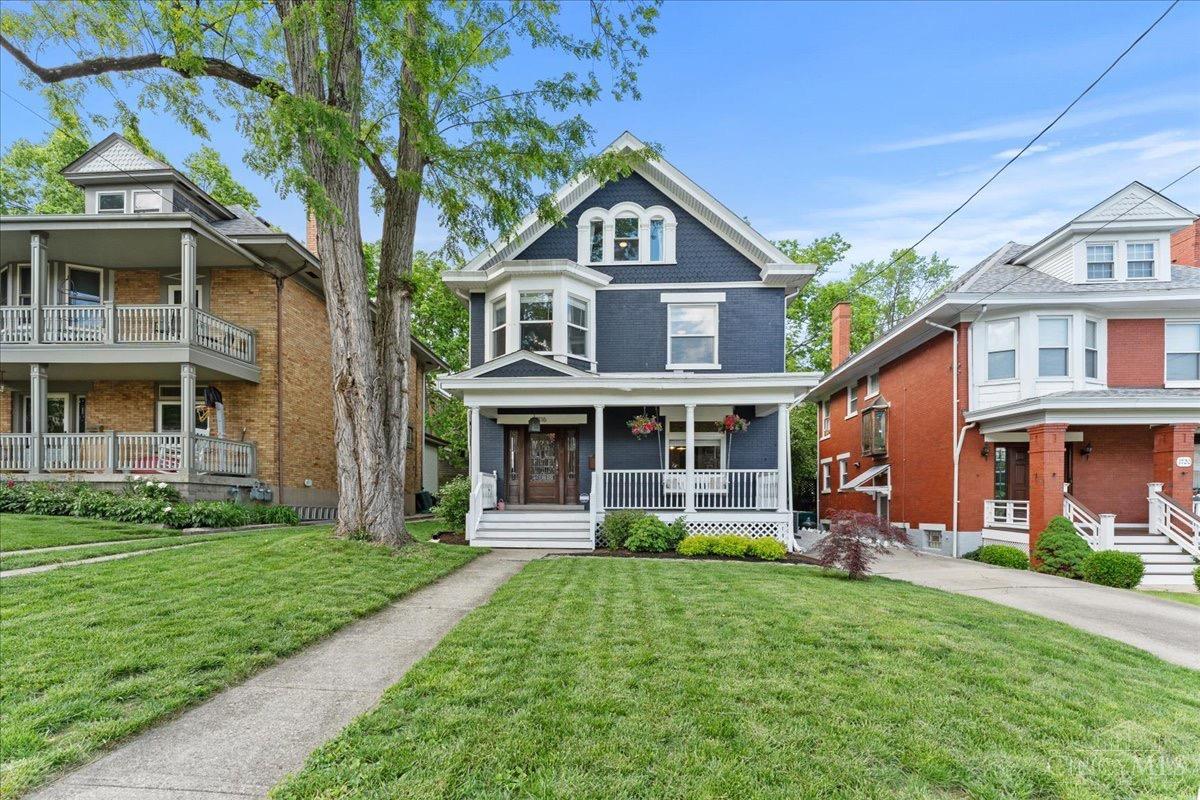 Did someone say pocket doors?! Welcome to this beautiful historic home located in the ever-popular East Walnut Hills! Step inside from the inviting front porch into an impressive open entryway featuring a classic hardwood grand staircase. The dining room boasts a fireplace with original woodwork and marble tile, which can be enclosed with the historic pocket doors. Be sure to catch the large window that floods the space with natural light, along with a gorgeous stained glass transom that highlights the home's charm. Upstairs, you'll find another stunning stained glass window, three spacious bedrooms, second-floor laundry, and a full bath. The third-floor primary suite is a show-stopper, full of natural light and complete with an updated ensuite bathroom featuring a double vanity, large shower, and walk-in closet. All this, walkable to shopping, dining, entertainment, and more! Don't miss this incredible opportunity!