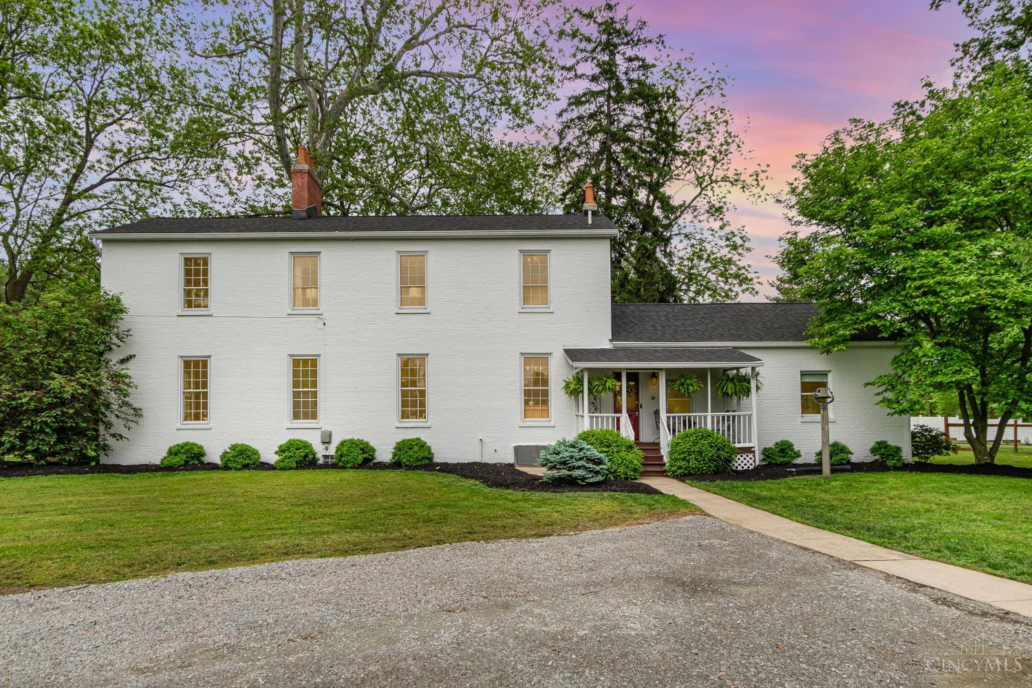 Stately brick Colonial on 2.64 fully fenced acres with an 8-car detached garage - one bay is heated. Believed to be the 2nd oldest home in Sayler Park (c. 1842), this historic gem features a grand staircase, natural woodwork, 4 fireplaces, and hardwood floors. Spacious living/dining areas, 2 full baths remodeled in 2017, first-floor laundry, and 2 lower-level bedroom additions in the 90s. Two bedrooms feature new (2024) climate control units. Numerous updates: roof & water heater (2021), Bosch appliances (2022), interior/exterior paint, kitchen cabinetry, fixtures, and more. A rare opportunity!