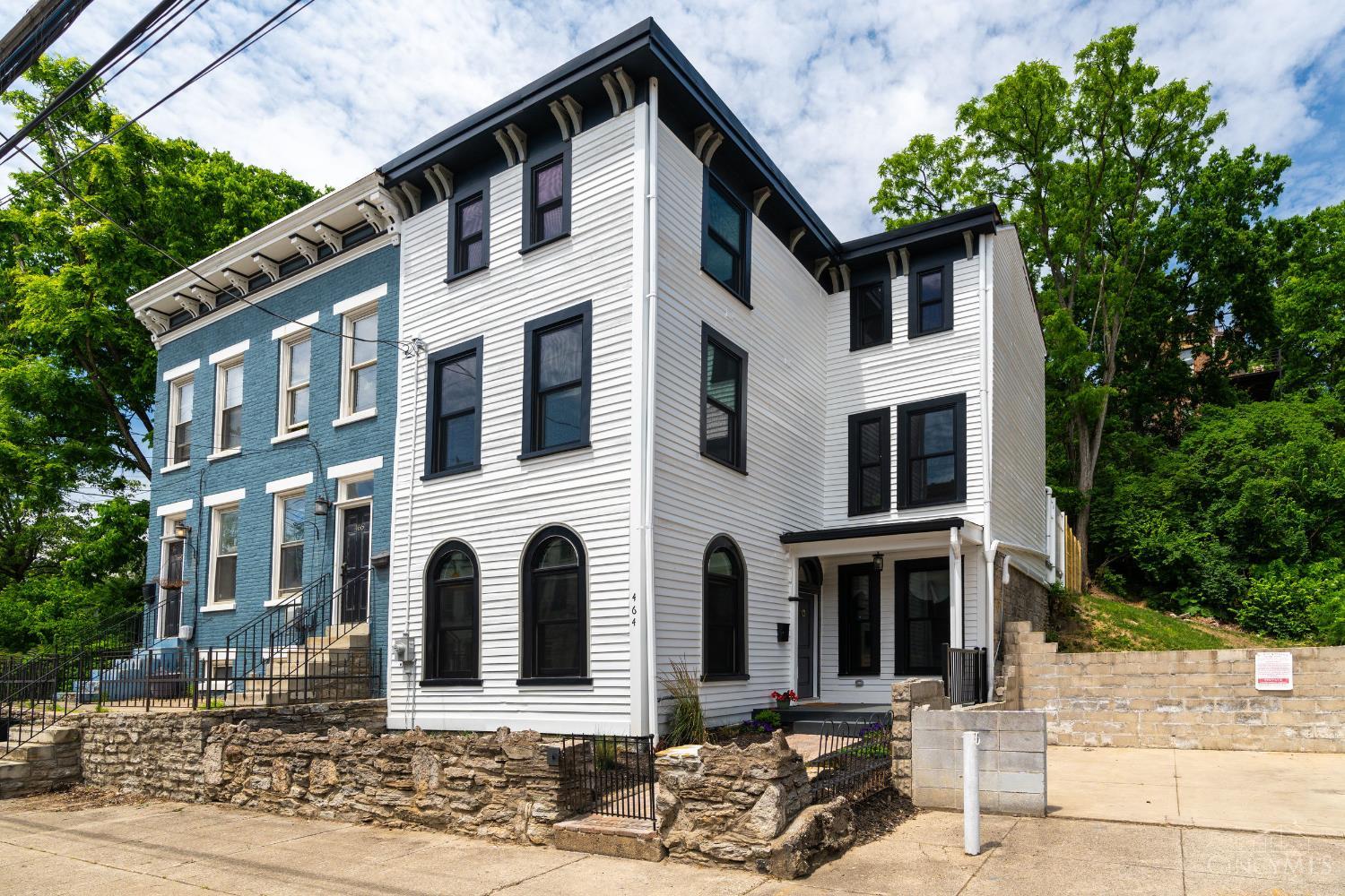 Stunning, one-of-a-kind, Italianate revival in historic OTR! Captivating single-family home, lovingly restored from top-to-bottom, w/incredible attention to detail, includes not only one but three private outdoor spaces! Showered in light w/huge brand new windows, gorgeous oak floors, quartz & marble counters, sparkling new kitchen w/incredible pantry space + deluxe primary bdrm and bath, w/huge walk-in closet and laundry! Charm and character throughout w/original woodwork, fireplace mantles, 10ft ceilings and outdoor gardens. All with the mindful ease of your modern updates including all new electric, plumbing, windows, roof, zoned HVAC system, etc. Enjoy summer days on charming covered front porch, or backyard walkout patio w/generous fenced-in green space, OR incredible rooftop deck featuring beautiful city views! 10 year tax-abatement application in process! See feature sheet for full list of updates. Quiet street with easy parking, steps from TQL Stadium and iconic Findlay Market.