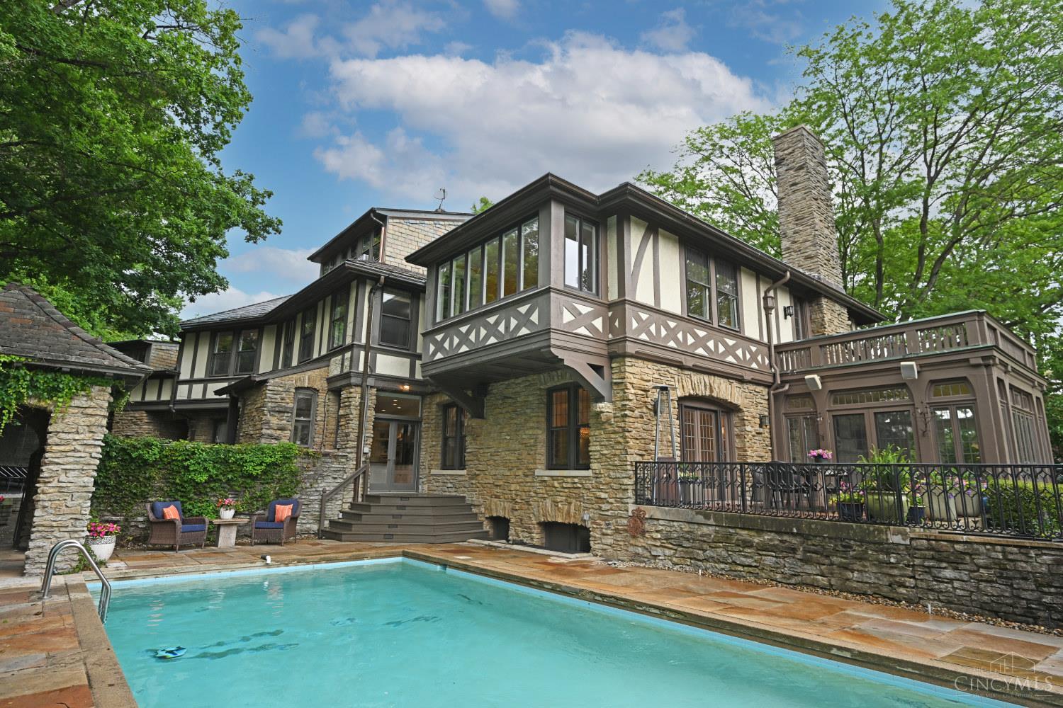 Tucked behind Madison Road on a quiet private lane, this elegant Tudor is a very special property.  Large inviting rooms with open floor plan feel luxurious. This house includes a private pool and expansive outdoor entertaining area which is accessible through the living room, dining room and kitchen.  Solarium off of the living room fills the house with natural light.  The oversized garage fits four cars and has a nanny suite above it that is also connected to the second floor. Beechcrest is one of Cincinnati's finest streets located in East Walnut Hills.  It's a short walk to O'Byronville and Woodburn business districts and 10 minutes to downtown.