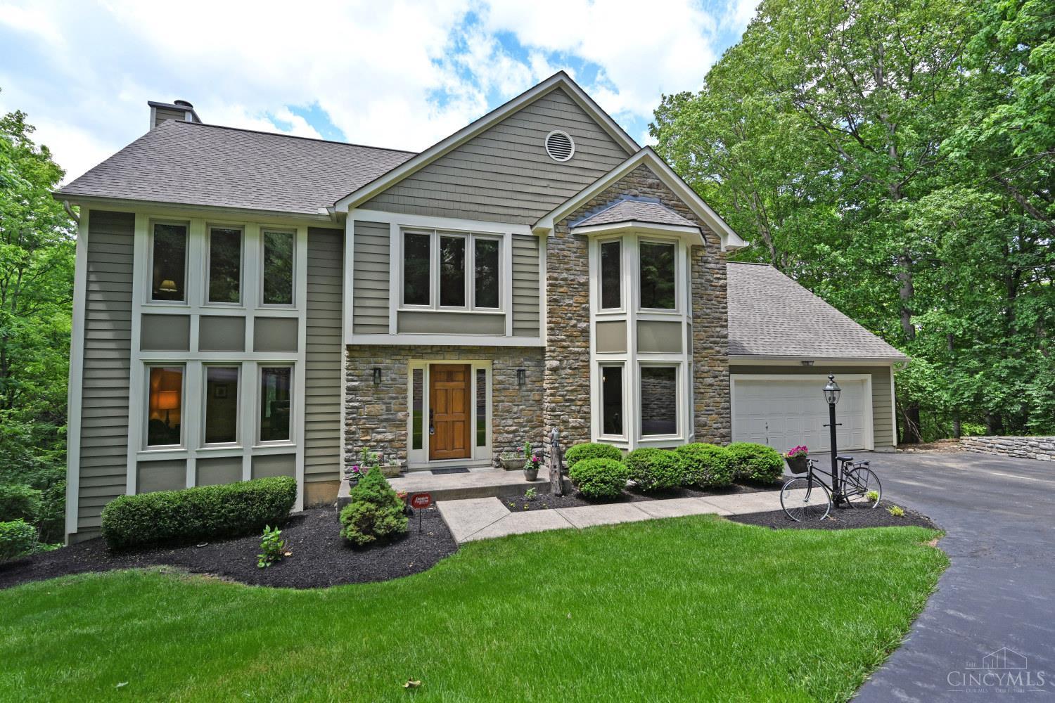 Pride of ownership shows in this beautifully maintained Zicka built home that is tucked away in its own little corner of Paradise! Feel your blood pressure lower as you make your way down the lane to your Perfectly Private retreat surrounded by trees on almost 2 acres of Nature at its finest. Low maintenance inside and out, you'll appreciate the solid build with Hardie Plank and Stone exterior, newer front windows, roof 2022 with seamless gutters and hardwood floors, Stainless Steel and granite fixtures inside. You'll appreciate the many expansive windows that give you the beautiful views outside while providing the light and bright feeling inside. And providing even more room and living space, the Lower Level, with wet bar and FULL bath, has a walkout to your tiered deck, all the while still leaving tons of storage space.