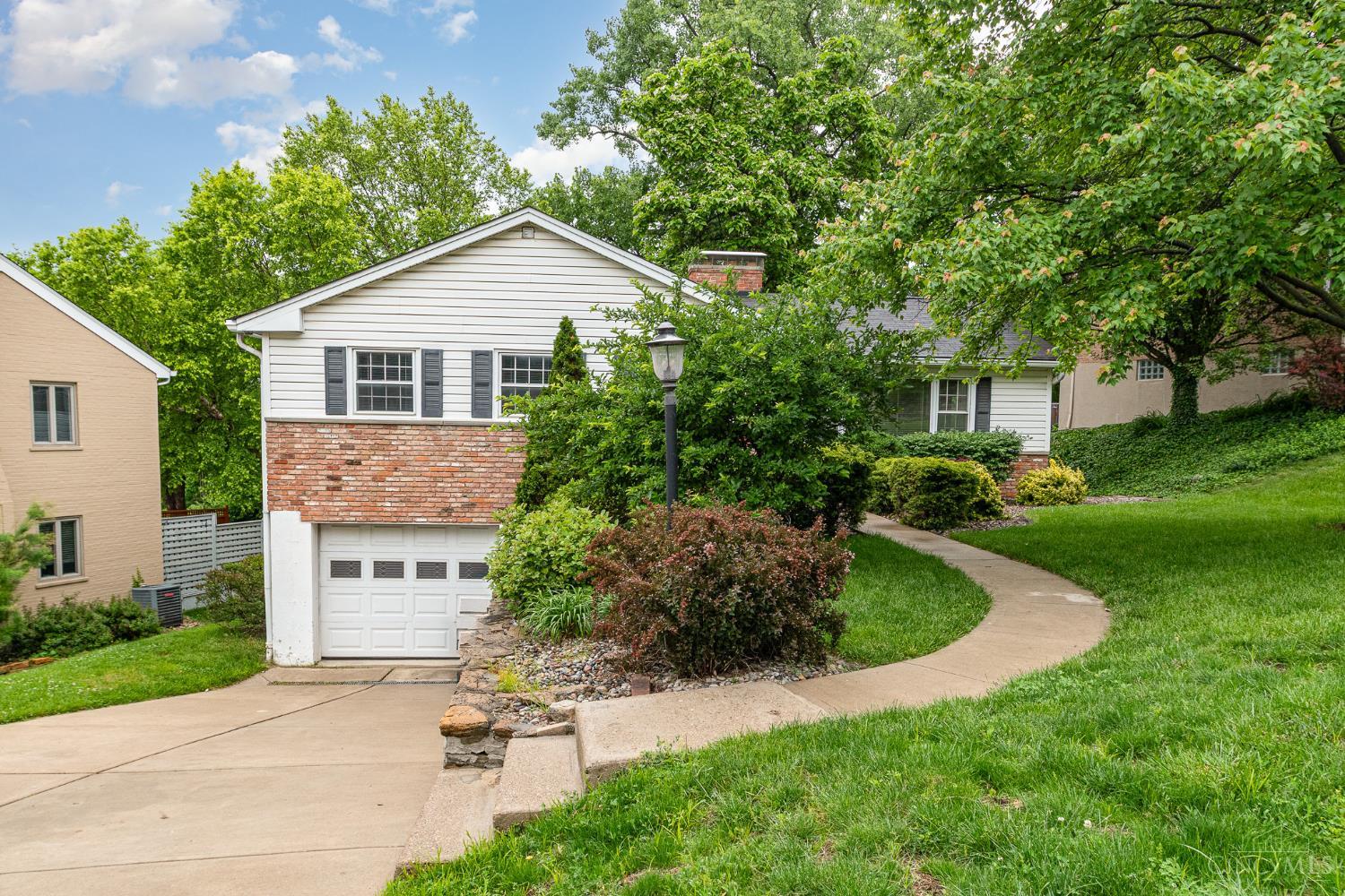 Gaslight district charmer with multigenerational living or supplemental income potential! Well-maintained ranch featuring light-filled living room with brick fireplace, formal dining area, large kitchen with stainless appliances, primary suite with attached full bath, and finished walkout lower level that could operate as a standalone apartment with egress bedroom and full kitchen/bath. Gorgeous hardwoods thruout 1st floor. Neutral paint and finishes throughout. Plus an attached 1-car garage and rear patio overlooking a park-like yard. All on a quiet street minutes from hospitals + downtown!