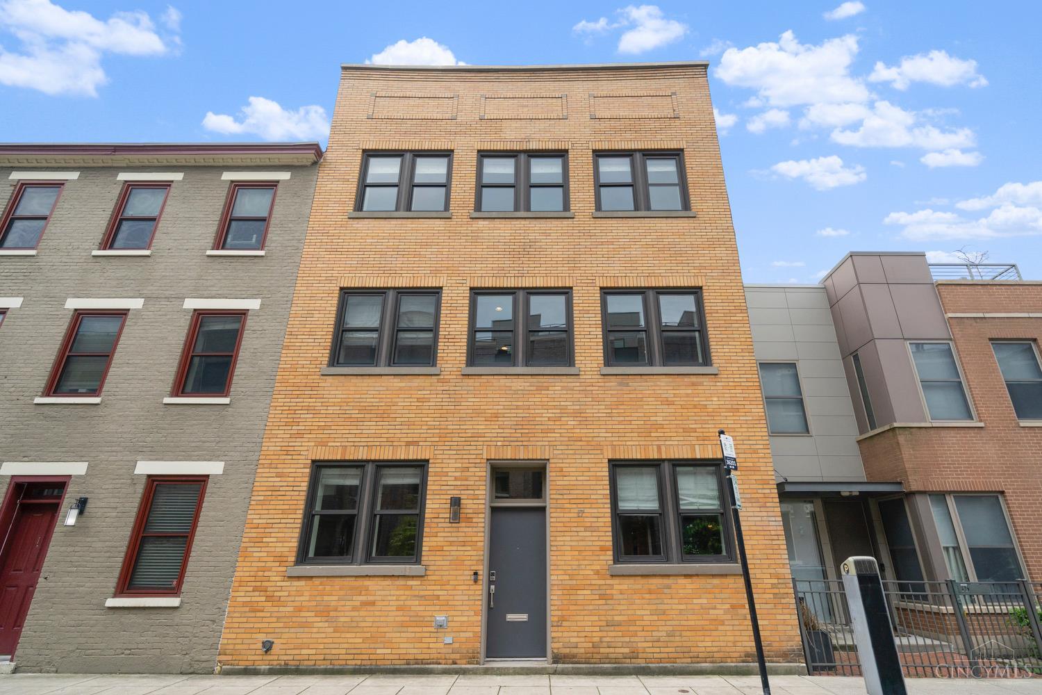Architectural charm meets modern luxury in this pristine 3 story condo in the heart of OTR! This historical building was fully renovated in 2013 - 3 bedrooms - each with its own full bath, open concept kitchen, living & dining rooms. Primary en suite boasts a skylight, double closets, dressing area & modern bathroom. Two outdoor spaces to entertain - deck off of the dining/kitchen & a private lower level deck with turf & storage. First floor bedroom is currently set up as an office.  Mercer Garage just a few doors down for parking. Hdwd floors refinished & interior paint in 2025. Close to all that OTR has to offer!