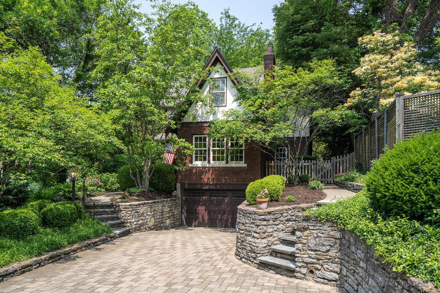 Stunning 4BR Tudor on one of Mt. Lookout's most sought-after streets! This timeless 1929 home blends original character of hardwood floors, fireplaces & rich trim with thoughtful modern updates. The beautiful chef's kitchen (2019) features quartzite counters, custom cabinetry, and opens to a spacious family room with walkout to a private, fenced yard. Enjoy a formal living room, dining room, dedicated office, and a family room all on the first floor. Second floor boasts 4 bedrooms plus a bonus room (perfect 2nd floor playroom/office or ideal spot to add another full bath) and 2 updated full baths. Luxurious primary suite includes a marble double vanity, walk-in shower, and custom closet. Finished lower level adds rec. room, full bath ready for your updates, and garage access. New roof (2024) & newer Marvin & Andersen windows throughout. Just minutes from Ault Park, Mt. Lookout Square, and downtown Cincinnati. Showings start 1pm Friday, June 6th.