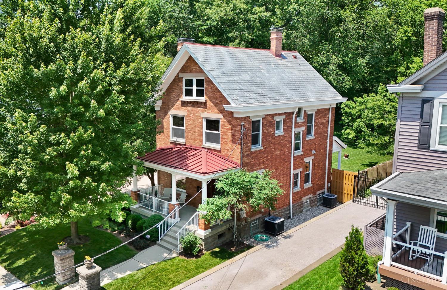 Amazing restoration of original features plus meticulous renovations to this historic brick home! One of the BEST yards in Columbia Tusculum. This remarkable home showcases exquisite original woodwork and timeless craftsmanship rarely found today. From intricate moldings to solid wood doors and custom built-ins, every detail shows off the care and quality.The foyer makes a stylish first impression with rich hardwood floors and beveled glass. Pocket doors open to the elegant and welcoming Dining Room, complete with a gas fireplace. Custom designed Kitchen with high-end Subzero and Dacor appliances. Marvin Windows. All Bedrooms feature California Closets and nice wood blinds. Flexible space for Bedrooms, Home Office, Guest Suite, Family Room. Newer two car Garage 2024. Beautiful, flat yard with peaceful wooded views! Fun location to walk to dinner and nightlife!