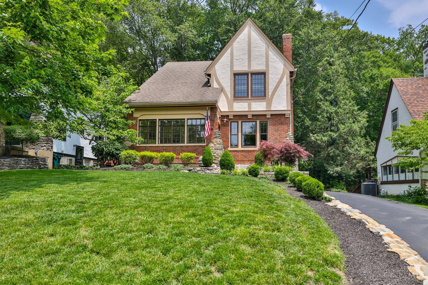 Beautifully updated Tudor in a prime location near parks, Mt. Lookout square, and schools. This well-maintained home features a high-end kitchen with painted cabinetry, quartz counters, tile backsplash, new appliances, and hardwood floors. It includes updated baths, spacious rooms, ample closet space, all on a gorgeous lot with a wooded view. The enclosed 3-season front porch has new exterior doors throughout. There is also a built-in oversized tandem garage, a half bath on the first floor and basement, and new furnace & AC installed in 2022.