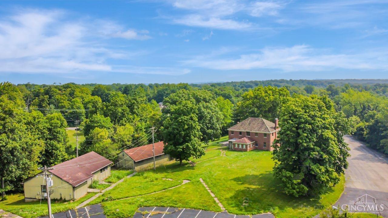 The perfect development site on a rare 25+ acre parcel in central Hamilton County.   The tree line, topography, elevation and meandering creek give this location views, privacy and a tranquil ambiance while still being easy to access and build on.   Infrastructure, level pads, and utilities are already on site and in place. Including 56,800 Sq Ft. of roads, driveways and parking.    Includes 5 solid building shells, totaling 12,823 Sq. Ft. per Ham Co. Auditor. All need varying amounts of rehabbing. Currently zoned R-2,    Could be commercial or multi-family, residential, horse or agricultural, a church, corporate retreat all kinds of uses. Multiple access points.   Come Look at this exceptional property.   There is nothing like it on the market.