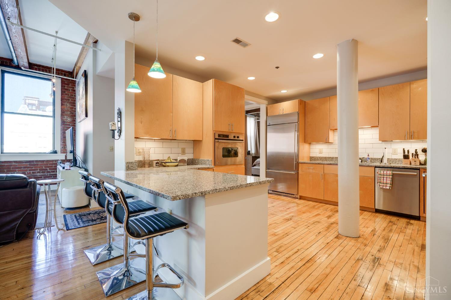 Experience the perfect blend of historic charm and modern luxury at the Lofts of Graydon Place in this stunning 2-bedroom, 3-bath condo with a den in the heart of Downtown Cincinnati. Featuring exposed brick walls, soaring wood beams, refinished hardwood maple floors, and high ceilings, this spacious residence offers an authentic urban feel with upscale finishes throughout. Enjoy unmatched walkability to stadiums, the Aronoff Center, top restaurants, and entertainment. Take the private elevator directly into your unit in this secure, highly sought after building. Two assigned parking spaces included-a rare downtown perk. Don't miss your chance to live in one of the city's most coveted locations!