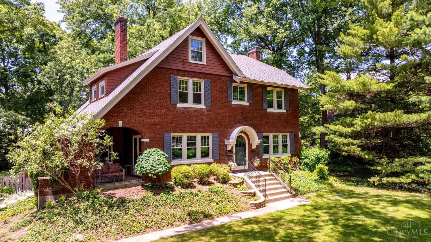 Meticulously maintained brick Transitional/Tudor blends timeless character with thoughtful updates across 2,506 sq&#8239;ft. The remodeled eat-in kitchen features a center island and breakfast nook, flowing into formal living and dining areas with crown molding, natural woodwork, built-ins, and original oak floors. Five bedrooms include a flexible third-floor suite with full bathideal for a home office, guest space, or creative use. Additional highlights include updated baths, insulated windows, a main-level powder room, wood-burning fireplace, French doors, and an unfinished basement with walkout access. Situated on a .44-acre level lot with fully fenced in yard, a rear-entry 1-car garage, and a charming gas-lit street location near Pleasant Ridge schools and local amenities.