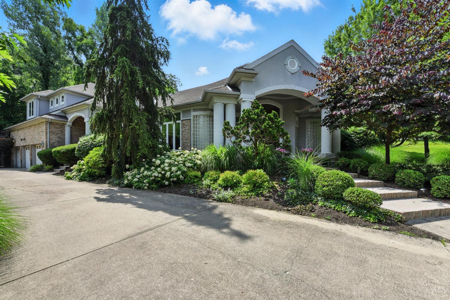 Exquisite One-of-a-Kind Retreat in Sought-After Hyde Park.Nestled on a beautiful, tree-lined cul-de-sac in the highly desirable Hyde Park neighborhood, this stunning custom home offers elegance, comfort & exceptional livability. From the moment you enter, you're greeted by soaring volume ceilings, rich Brazilian cherry floors & an incredible open-flow layout designed for both everyday living & effortless entertaining.  The main level features a luxurious first-floor primary suite, while a private in-law suite provides ideal accommodations for guests or multigenerational living. Every detail has been thoughtfully crafted from a seamless blend of timeless charm & modern functionality. Step outside & discover your own bucolic backyard retreat, perfect for relaxing, gardening, or entertaining. Surrounded by mature trees and lush landscaping, this peaceful outdoor haven offers a serene escape in the heart of the city.