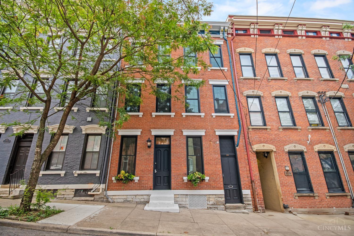 Don't miss out on this stunningly restored Italianate row home in the heart of Pendleton. With over 3,600 of finishedsqft, this house yields a versatile open-layout suited to a variety of living arrangements. Offering a rare combination of historic character and modern updates, original details like 10'+ ceilings, refinished hardwood flooring throughout, and a grand staircase are complemented by a renovated kitchen with custom Shaker cabinetry, quartz countertops, a pull-out pantry, and island. A private third-floor guest suite includes its own kitchen, bathroom, laundry, and HVAC --all added in 2017. The fourth floor (approx. 1,100 sqft) is ready for your vision:roughed-in with electric and plumbing. Additional features include a spacious patio, Nest thermostat, keypad entry, and bike storage system via the breezeway. Walkable to Ziegler Pool, parks, dining, and the streetcar as well as easy access to I-71 and I-471. Schedule your private showing today!