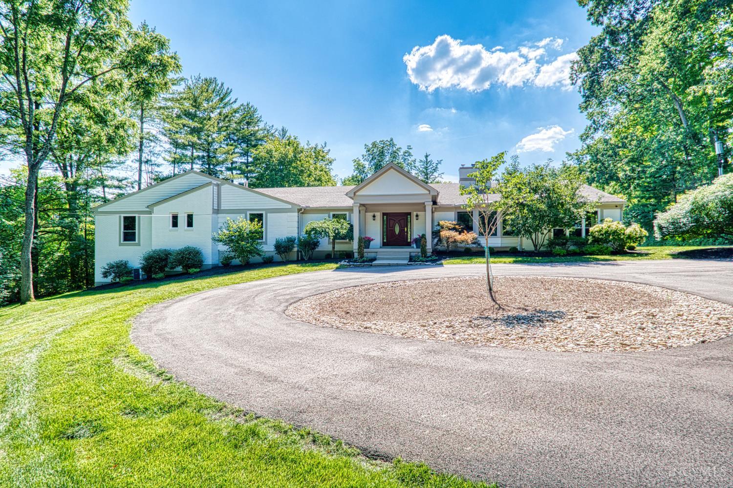 Sprawling 8200 sqft ranch nestled on 3 acres in prestigious Indian Hill.  This beautifully designed home is where modern elegance meets everyday comfort. With Seven bdrms, 6.5 baths, 2 kitchens, and 2 laundry rooms, there's room for everyone to live, relax, and entertain in style. Clean lines and a sleek, contemporary feel flow throughout, complemented by warm touches like 5 gas fireplaces including a stunning dual-sided FP and a classic wood-burning fireplace. The spacious open kitchen is flooded with daylight from the wall of windows with a hearth room that invites gathering.  The primary suite is a serene retreat with a luxurious bath, dressing room, huge WIC.   All new Pella windows bring in natural light and energy efficiency. Added perks include surround sound, 3 HVACs, 2 attic fans, new circular driveway. The covered patio and flat private rear yard has endless potential. This is a rare opportunity in one of Ohio's most desired neighborhoods.