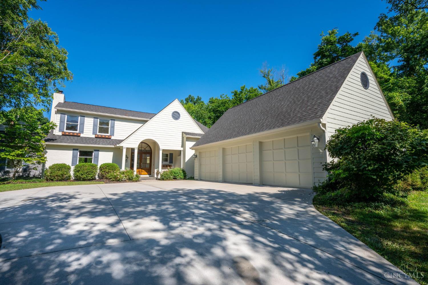 Timeless elegance meets modern luxury in this exceptional two-story, tucked away on 1.7 beautifully landscaped acres in sought-after Indian Hill. Bathed in natural light, the home boasts 6 BD & 5 full BA, with refined 1st floor living. The gourmet kit with limestone floor is a true gathering space-perfect for culinary creations or gathering place-while the large laundry room & 3-car side-entry garage add everyday convenience. The vaulted first-floor primary suite is a serene retreat, complete with a cozy fireplace, spa-like BA, walk-in closet, & walk-out to the patio. Guests will love their own suite featuring a fireplace, built-ins, vaulted ceiling, & private BA. The finished lower level invites effortless entertaining with a full wet bar, wine fridge, & walk-out to your personal backyard oasis-complete with pool, stone water feature, & lush, private surroundings.