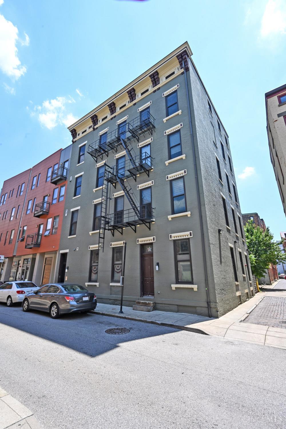 Stunning 3-Bedroom Condo in the Heart of OTR. Now Available! Don't miss this rare opportunity to own a beautifully designed, multi-level condo in Cincinnati's vibrant Over-the-Rhine neighborhood. This spacious residence offers over 1,800 square feet of modern living, featuring 3 bedrooms and 3 full bathrooms. The expansive master suite spans the entire second floor and includes a versatile workout or rec room area, a luxurious en-suite bath, and a generous walk-in closet. Enjoy high ceilings, exposed brick walls, and an open-concept layout that seamlessly connects the gourmet kitchen to the sunlit living area. Additional highlights include an in-unit laundry, private balcony, pet-friendly building, transferrable parking spaces in The Mercer Garage, 1st floor bedroom with en-suite, ample storage, thoughtful interior design, and located on the top floor for exceptional light and privacy. Experience the perfect blend of luxury and city living. Schedule your private tour today!