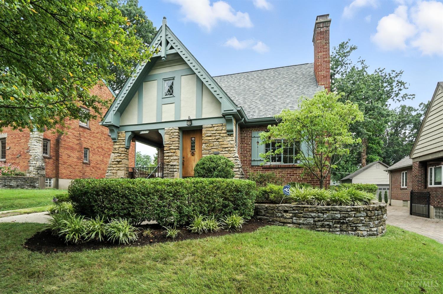 Classic & pristine Tudor located on one of Oakley's most desirable streets. A welcoming living room opens to a covered side porch. The spacious dining room offers plenty of room for hosting, while the kitchen is timeless, fun and functional. A quaint breakfast room adjoins the kitchen. At the rear of the first floor, you'll find two generously sized bedrooms and a full bathroom. Upstairs, the large primary suite is a true retreat, featuring an oversized walk-in closet and a spa-like bathroom complete with heated floors, a jetted tub beneath a large skylight and a TV for ultimate relaxation. The finished lower level provides additional living space, a half bath, and abundant storage. Don't miss the  beautiful details like the cove ceilings and hardwood floors. Location is A+ with Wasson Way at one end of the street and Oakley Square at the other. Quick access to I-71 means you're just 10-15 minutes from downtown. This home is ready for you to move in and enjoy! Showings begin 7/17.