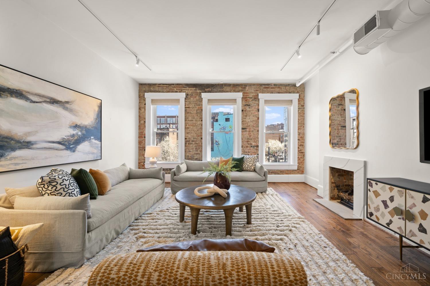 Welcome to urban luxury in the heart of Over-the-Rhine! This stunning 3-bedroom, 2-bath condo spans four levels and features high-end finishes throughout, offering a perfect blend of style and functionality. Enjoy your own private rooftop patio, ideal for soaking in breathtaking city views, private entrances, and a great size basement for storage.  With two assigned parking spaces in a gated back lot, you'll never have to worry about street parking. Located just steps away from OTR's vibrant dining, shopping, and cultural scene, this residence is a true urban gem. Updates include: Custom Closets throughout, Remodeled Bathrooms, New Kitchen Countertops w/ Waterfall Island, New Electrical Work and Painting Throughout. Building offers elevator access to unit.