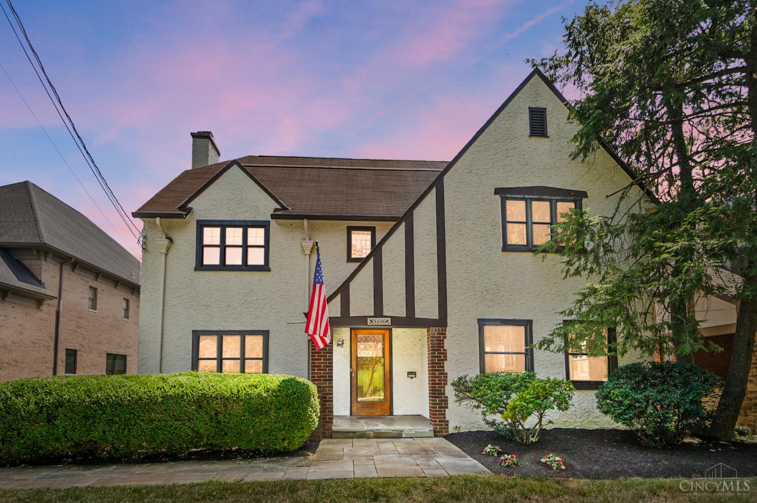 Nestled on one of Mt. Lookout's rare gaslamp streets, this 1927 Tudor is a rare blend of timeless elegance and modern comfort. From the welcoming stained-glass door and iconic Rookwood fireplace to the expansive cathedral-ceiling great room and open kitchen, every inch is designed for gracious living. Original crown moldings, and custom woodwork preserve the charm.  Multi-level deck with caf lights offers the ultimate outdoor escape. With 4 bedrooms, 2 full baths (including a steam shower), and a dreamy 3rd-floor retreat with clawfoot tub, this home offers space, style, and soul. Walk to Kilgour School & Ault Park. 3-car garage, workshop & unbeatable curb appeal on a street no one wants to leave.