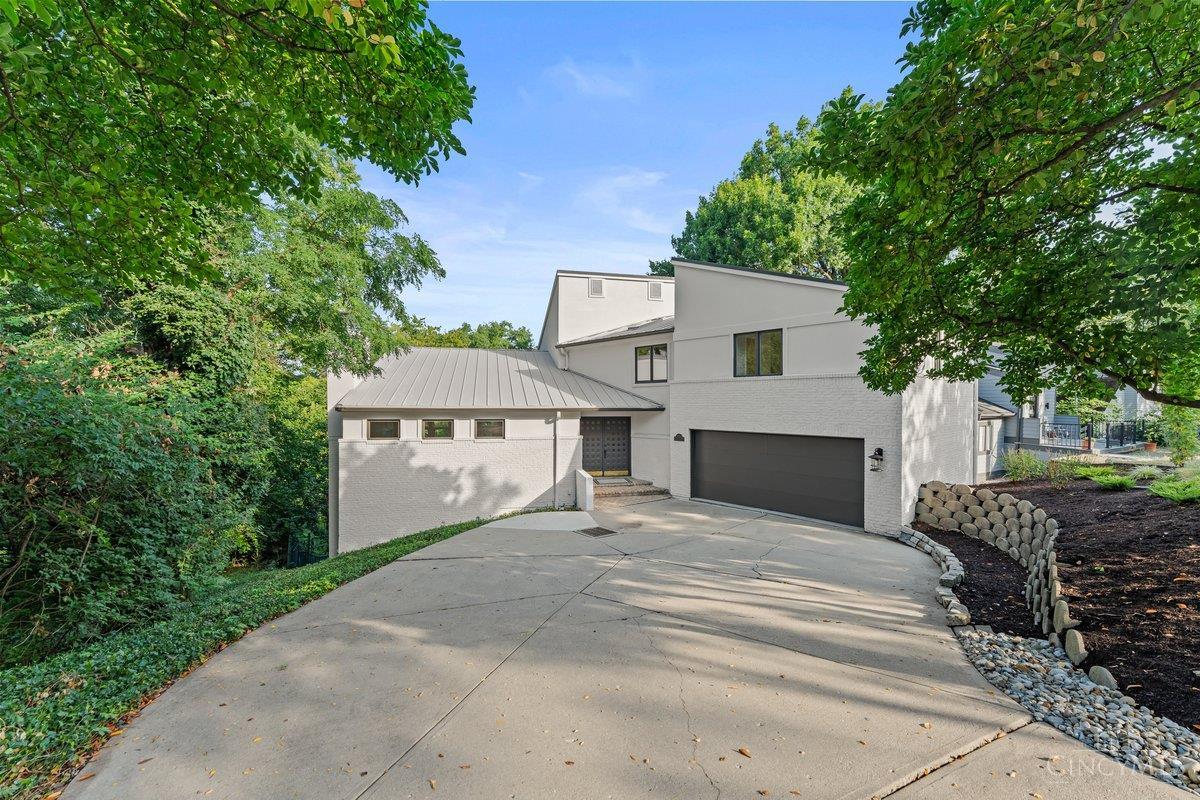 Discover the perfect combination of style, space, and serenity at 436 Flinn Ave., a truly rare find in the Cincinnati market. Tucked away on a quiet, one-way street, this exceptional 4-bedroom, 3.5-bathroom transitional home is poised on an expansive double lot and has been owned by the same person for over two decades, serving as a stable, long-term asset and investment property.  As you step inside, there's an inviting open floor plan with beautiful contemporary design. The home offers 3331 finished sq ft of living space, with an expansive lower level, and an unfinished space: perfect for an XL Laundry, custom workshop, or home gym.  Highlight of this property: the outdoor spaces - surrounded by mature trees that create a private, serene atmosphere. A two-car garage provides ample storage and convenience.    This home offers a secluded retreat just minutes from everything Cincinnati has to offer.    Located 500 feet from state route 50. & 4.2 miles from I71
