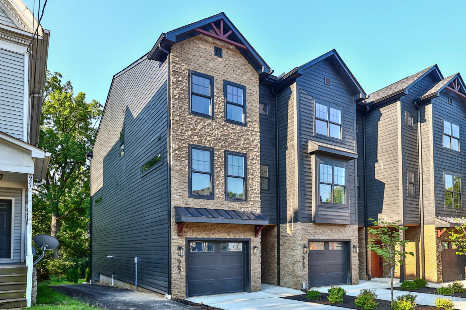 New Gold LEED-certified townhome in Walnut Hills. 2,300+ sqft of elevated, on-trend design. Open layout with tall ceilings, natural light, hardwood floors, gas fireplace, gorgeous fixtures and finishes throughout. Gourmet kitchen features a large island, quartz counters, pantry, stylish backsplash, and stainless appliances.3 beds, plus flex room for a 4th, each with its own private en-suite bathroom. Primary suite features a walk-in closet and spa-like bath. Conveniently placed laundry near bedrooms. Walkout deck with wooded views plus a covered lower patio and tree-lined backdrop. Oversized garage, guest parking, and 15-year tax abatement. Nearby parks, shops, dining and more! Just minutes to downtown, I-75 and Columbia Parkway. Last end unit left!