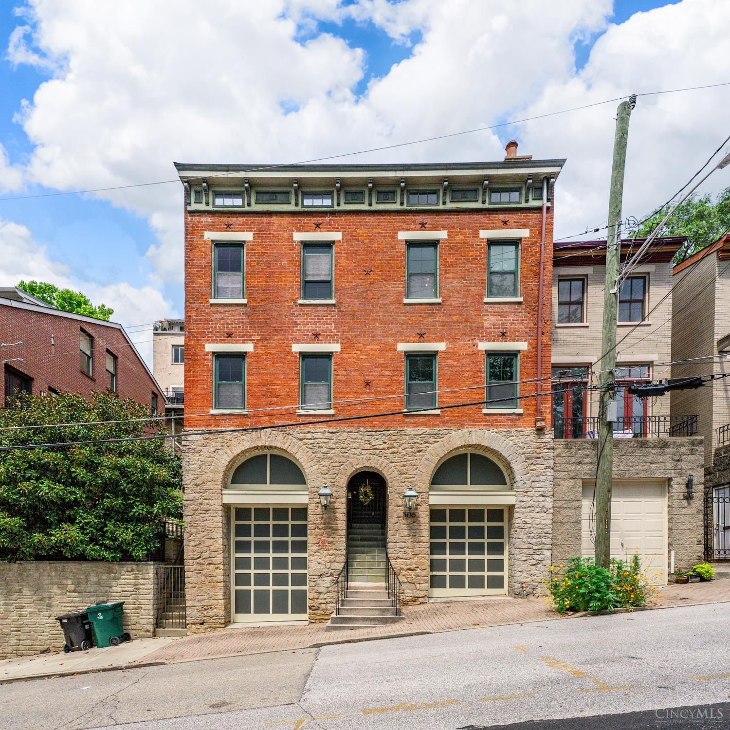 A Queen City hidden gem awaits in the heart of Historic Prospect Hill. This rare Italianate treasure is steeped in history. Once a working stable house, this distinctive property was reimagined in early 1990s by architect Donald Beck, who infused it with historic character and modern artistry. At its center is an enclosed glass light-well courtyard that floods with natural light while providing a striking, space to showcase art without the risk sun exposure. Elegant Tuscan columns, an open floor plan, and thoughtful design invite you to move through 3 levels via the staircase or the convenience of an elevator. 3 bedrooms, 2 full and 2 half bathrooms, a private slate rear patio, and a rooftop deck offer comfort and versatility, while the home's one-of-a-kind architecture and historic flair earned it a feature in Great Houses of the Queen City. Just minutes from downtown Cincinnati, it provides easy access to highways, NKY, Findlay Market, theaters, museums, and diverse dining options.