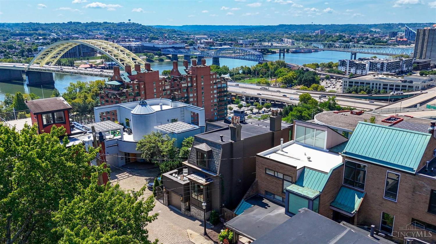Best City & River Views! This exquisite home has been thoughtfully renovated with a focus on its breathtaking views. Floor to ceiling custom bronze windows, gorgeous wood floors, & recessed lighting are standout features. The chef's kitchen boasts Franke, Rohl, Thermador, & Sub-Zero appliances, a Calcutta marble countertop, & custom cabinetry. Enjoy entertaining in the spacious living room framed by expansive windows, or retreat to the primary suite featuring serene views, a fireplace with custom stone mantle, a renovated spa-style bath, & a walk-in closet. The second bedroom is equally well appointed, while a sunroom/office offers even more views to enjoy. Expansive decks provide the perfect setting for outdoor gatherings. Additional highlights include a garage with an electric car charger & many recent updates. Conveniently located with easy access to downtown, NKY, & major highways. Offers open for 48 hours. No escalation clauses.