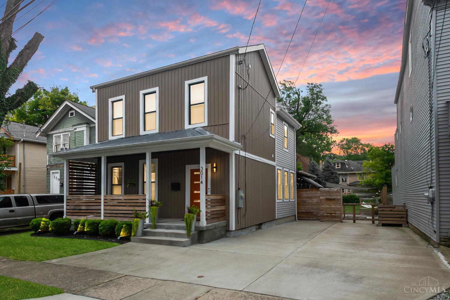 Located in desirable East Walnut Hills, this 3-bedroom, 3-full bath home blends modern design with timeless charm. A welcoming front porch opens to an entry with a striking architectural staircase and airy, open-concept living. The spacious living room boasts hardwood floors and an exposed brick accent wall, flowing into a chef's kitchen with waterfall island and sunlit dining area. A flexible main-level space is perfect for a home office, reading nook, or family room. Upstairs, the primary suite offers a walk-in closet and spa-inspired bath with linen storage. A beautiful hall bath, convenient 2nd-floor laundry, and generous bedrooms complete the level. Step outside to your own private oasis: a large covered deck overlooking a serene, lush green yard designed for relaxation and entertaining, featuring a secluded hot tub area that feels like a resort retreatperfect for unwinding at the end of the day. Tax abatement that goes through 2032