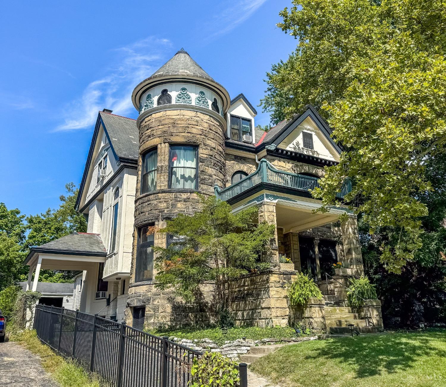 This historic Queen Anne mansion in Clifton Gaslight, cherished by only two owners since 1942. A masterpiece of preserved craftsmanship, it boasts exquisite original features, including imported woodwork, German fireplace mantels and tile, stained glass throughout, functional pocket doors, hand-painted ceiling murals, and a slate roof with copper gutters. Modern upgrades enhance its grandeur, featuring a gourmet kitchen, an expansive primary suite with laundry, updated HVAC, and a fully renovated exterior. Could be a grand single family or an income generating property with many options for multiple units/short term rentals. Current owners live on first two floors and generate $4,600 in monthly rental income from just the third floor and studio units. Total potential rental income around $9000+ monthly. Outdoor entertaining is elevated with a .23-acre additional parcel, while a 5-car garage/carriage house provides ample off-street parking.