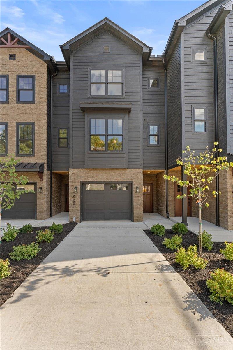 LAST 2 units left! First floor bedroom available in this floorplan. New Gold LEED-certified townhome in Walnut Hills. 2,300+ sqft of elevated, on-trend design. Open layout with tall ceilings, natural light, hardwood floors, gas fireplace, gorgeous fixtures and finishes throughout. Gourmet kitchen features a large island, quartz counters, pantry, stylish backsplash, and stainless appliances. 3 beds, plus a loft, each with its own private en-suite bathroom. Primary suite features a walk-in closet and spa-like bath. Conveniently placed laundry near bedrooms. Walkout deck with wooded views plus a covered lower patio and tree-lined backdrop. Oversized garage, guest parking, and 15-year tax abatement. Nearby parks, shops, dining and more! Just minutes to downtown, I-75 and Columbia Parkway.