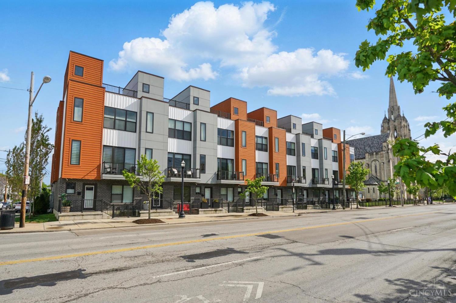 Modern Luxury in the Heart of Oakley - Tax abated through 2035, this 2020-built townhome offers 3 bedrooms, 3.5 baths. The open, light-filled main level features 9 & 10 ft ceilings, hardwood floors, a well-appointed kitchen with quartz countertops and wood cabinetry, plus dual balconies for seamless indoor-outdoor living. On the second floor, you?ll find a primary suite with two custom closet and an additional bedroom and full bath. The first floor adds flexibility with a bedroom/office and full bath. Private elevator, two-car garage with EV charger, and a rooftop deck with city views. Move-in ready and low maintenance!  All just steps from Oakley's top restaurants and shops!