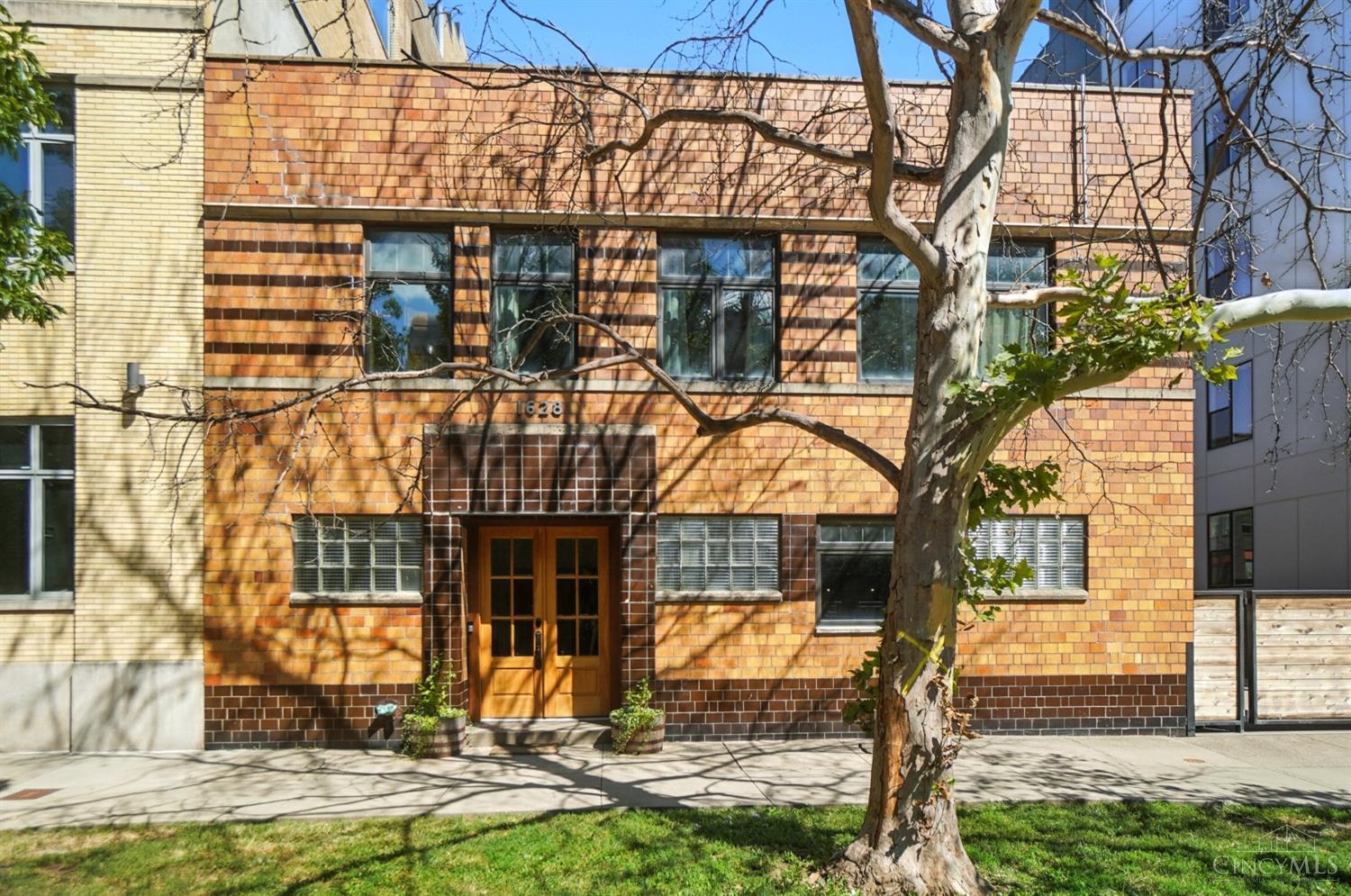 Own a piece of Cincinnati history at 1628 Central Parkway, part of Filmer's Row, originally built by Universal Pictures. This distinctive residence offers remarkable versatility with a 2-bedroom, 2-bath apartment upstairs and a 1-bedroom, 2-bath apartment on the first floor. Blending historic charm with modern updates, the home showcases refined, high-end finishes throughout. Standout features include a 6-car garage, 6 additional gated parking spaces, and a private outdoor retreat just steps from the FC Cincinnati stadium, new developments, restaurants, and downtown attractions. Purchased as a shell, the property underwent extensive renovations in 2013 with new windows, wiring, and plumbing. Further enhancements include a new AC and mini-split system in 2018, with a new roof scheduled within weeks. A rare opportunity to combine city living, investment potential, and historic character in one exceptional property.