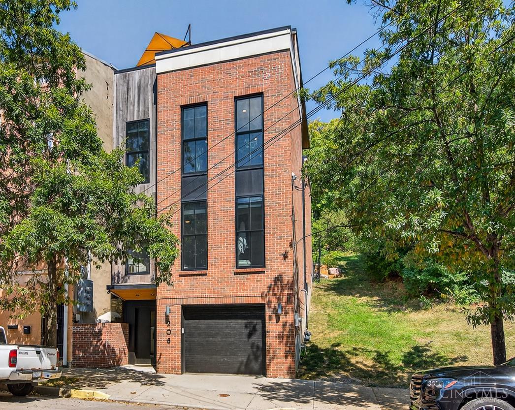 Perched in the prestigious, historic Main Street/Mt. Auburn incline, this stunning, four-year-new home flawlessly blends modern design with a cherished community setting. With nearly 2,900 sq ft of living space, this LEED Gold certified residence is a testament to sustainable luxury. No detail has been overlooked, from the master bathroom's heated flooring to the magnificent city views from the rooftop. The thoughtful layout features an open-plan living, dining, and family room with a walk-out to the private fenced yard, while the third floor hosts a flexible fourth bedroom and a great room with a private balcony overlooking Cincinnati's iconic skyline. Tax abated through 2037.