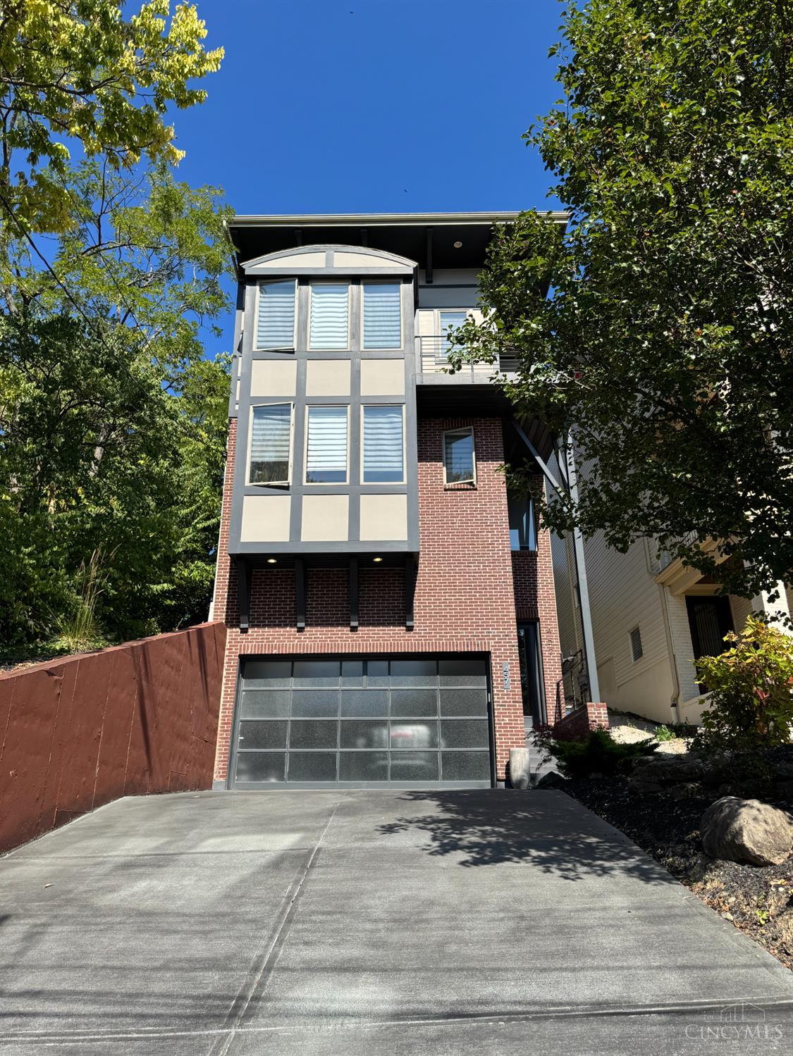 Breathtaking River + City views highlights this entertainers delight built with a modern flair. Four levels of luxury living. Features an open floor plan with chef's dream kitchen with custom island, desk area, high end appliances, Great room with coffered ceilings, picture windows/custom blinds, FP, built-ins, walkout to paver patio with custom fire pit, 1st floor study + built in cabinets, lower level media room with wet bar, luxurious primary suite with adjoining bath + custom closet with walk thru to Laundry room. Top floor with Rec Room, FP and sliders to Balcony to relish the river and city views & ambiance! Situated in the heart of Columbia Tusculum, close to restaurants/bars and Downtown Cincinnati. Must see to appreciate it!
