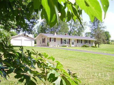 What a beautiful piece of land - 5 acres with a 3-bedroom ranch home, surrounded by woods, creek, pond and beautiful open land/sky views on a dead-end country road! The oversized 2-car garage provides storage and workspace. Upper back pasture is mostly fenced (left side at creek is not). Updated kitchen with plenty of wood cabinets, tiled backsplash, and stainless steel appliances. Large dining room could be dining/family room or office combo (seller is currently using as his office), living room has stone wall fireplace, bath has jetted tub & rain shower head. The septic was cleaned/leach lines flushed & extensive curtain drain installed 2023. Updated roof. Now's your time to enjoy peaceful and quiet living!