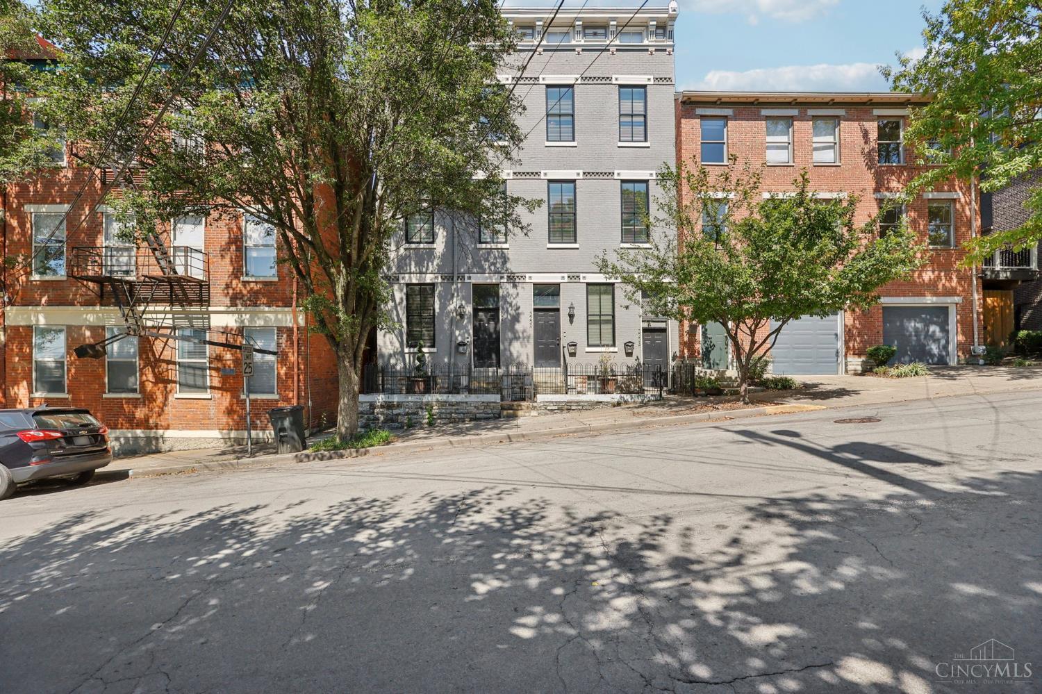 Rare 1,465 sq ft 3BD/2.5BA condo on scenic Mulberry St with stunning views of Downtown! Completely remodeled with high ceilings, large windows & refinished hardwood floors. Modern kitchen features subway tile, granite counters, stainless steel appliances & gas range. Top-floor primary suite w/study, 2nd-floor laundry. Currently operating as a successful short-term rental, generating ~$43,500 in 2024 with strong bookings secured through Oct 2025. Option to purchase fully furnished as a turnkey, income-producing property. Shared rear patio w/firepit. Short-term rentals allowed. Eligible for tax abatement until 2032 (applied for at closing). Perfect blend of residence, investment & location just minutes from downtown dining & entertainment.