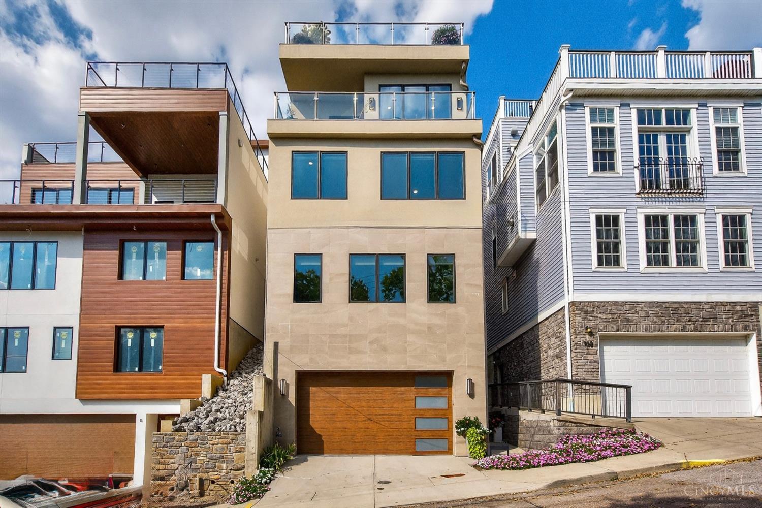 Looking for stunning city views, modern luxury, Platinum LEED tax abatement, Elevator and a Geo-Thermal home? This is the one! Built in 2020, this better-than-new home comes with a platinum tax abatement, making it an incredible opportunity! High-end finishes shine throughout, while two balconies overlook Downtown Cincinnati offering some of the best views in the city. This spacious 4-bedroom, 4-bath home also features an elevator to every floor, blending style with convenience. Perfectly situated near everything Cincinnati has to offer, you'll enjoy the vibrant lifestyle of the city just minutes from your door!