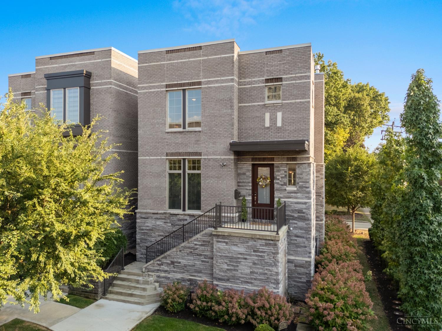 House Beautiful! This is a 3-story gem in the coveted Sanctuary Court of Walnut Hills! Enjoy the lush, shared courtyard & firepit, views of the historic bell tower, plus a $400K LEED Silver tax abatement through 2034! Close proximity to all of O'Bryonville and Woodburn Districts for shopping, eateries, pubs, and culture!  This home also offers soaring 10-ftnceilings which accentuate the open-concept design. A chef's kitchen with quartz counters, oversized island, walk-in pantry, wet bar & floor-to-ceiling cabinetry flows seamlessly to the living room with gas fireplace and dining space that opens to a large treetop deckperfect for entertaining! Generous Study with custom built-ins + powder room complete this level! The primary suite has dual oversized & custom closets, plus a skylit spa bath! There is a 2nd ensuite bedroom including a walk-in closet. Walkout LL offers a spacious 3rd ensuite bedroom & access to the 2-car garage with EV charging outlets.