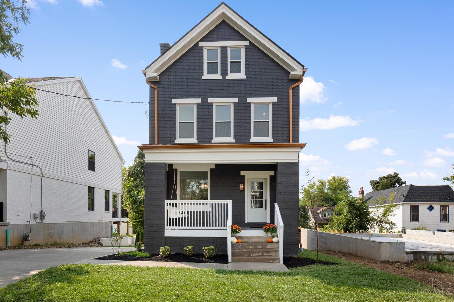 Full remodel & design by award-winning HGTV designer! This historic home features quality craftsmanship from top to bottom. Step inside to find charming details like a custom archway, exposed brick & double staircases. The kitchen features quartz countertops, stainless steel appliances, a statement backsplash & a walk-out to the private deck. New custom baths w/ high-end finishes. The primary suite features a walk-in closet, double vanity & oversized shower. The lower level offers a mudroom, laundry, storage & a walk-out. All systems have been replaced: roof, windows, HVAC, hot water heater, plumbing, electric + more. Fresh paint throughout, new flooring, landscaping, privacy fence, driveway & copper downspouts. Enjoy tall ceilings, natural light & ample closet space. Private yard for entertaining plus a front porch swing for relaxing. Located moments from East Walnut Hills DeSales Corner: coffee shops, restaurants & shopping. Seller applied for tax abatement, saving buyers thousands.