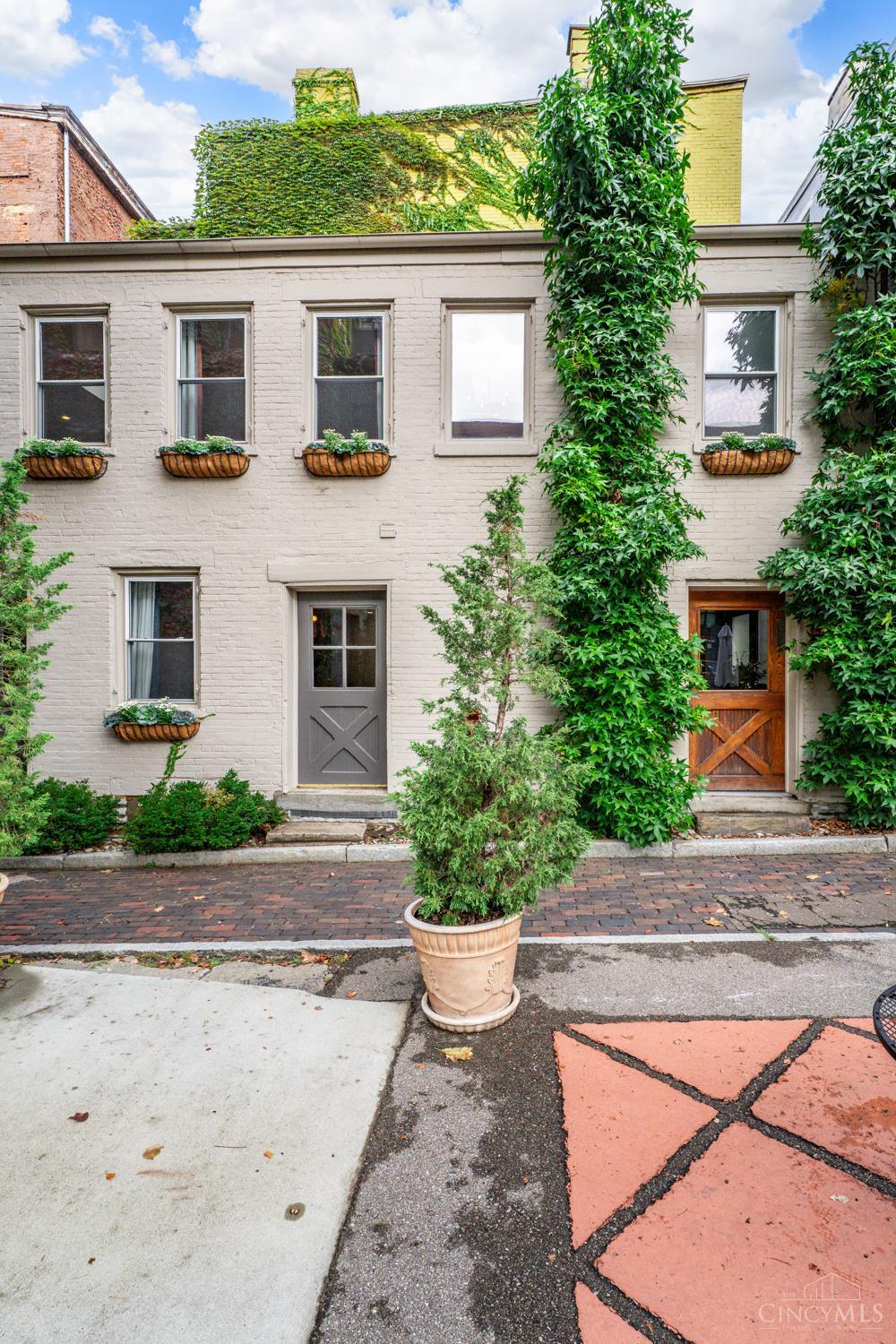 Discover The Carriage House on Grear Alley, a restored historic gem in Pendleton just steps from OTR's top restaurants, shops, and nightlife. Thoughtfully renovated, it blends character with modern luxury, herringbone floors, soaring ceilings, and a chef's kitchen with seating for five. The spacious bedroom easily fits a king, and the spa-like bath offers a private water closet, oversized shower, and clawfoot tub. Dedicated parking via a private cobblestone alley adds convenience, while the flexible floor plan makes it perfect for living or rental income. Featured in Cincinnati Refined and a successful short term rental, it has hosted guests from around the globe. Ideally located next to Saeso Cocktail Lounge and one block from Ziegler Park, this rare home puts you minutes from Washington Park, the streetcar, and all OTR has to offer, a true opportunity to own a piece of Cincinnati history.
